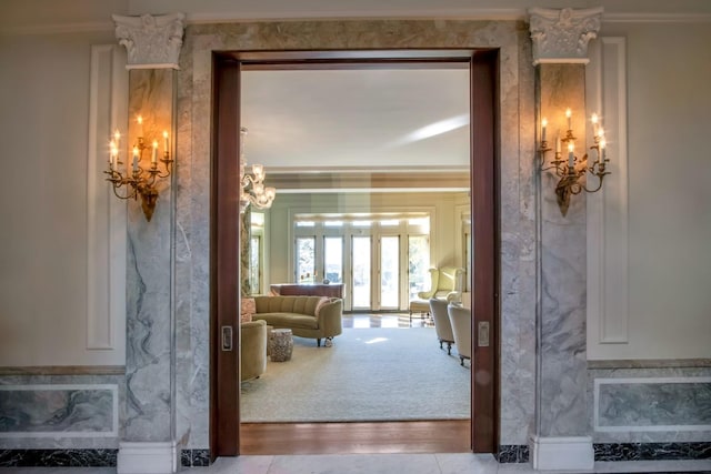 interior space featuring crown molding and a notable chandelier