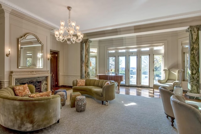 sitting room featuring carpet flooring, crown molding, a chandelier, and a fireplace