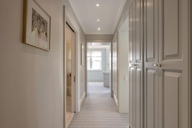 hallway with light colored carpet