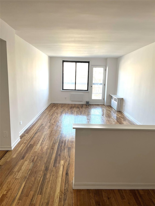 empty room with wood finished floors and baseboards