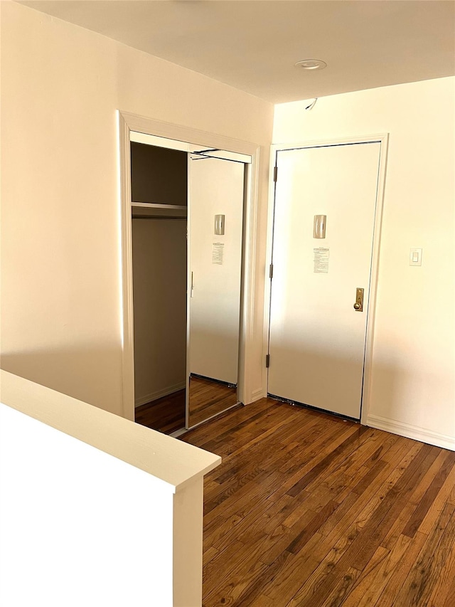 interior space with a closet and dark wood-type flooring