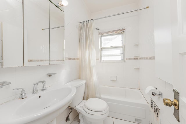 full bathroom featuring sink, shower / bathtub combination with curtain, tile walls, and toilet