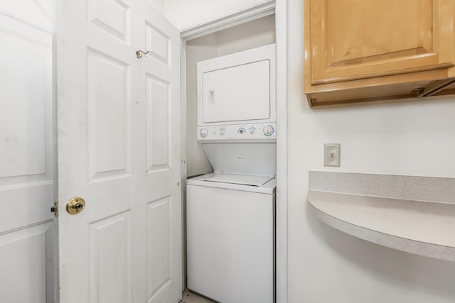 laundry room with stacked washer and dryer