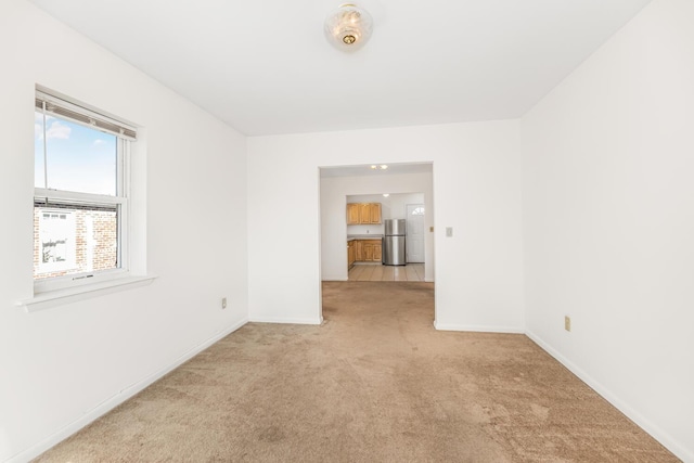 unfurnished room with light carpet