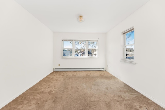 empty room with light colored carpet and a baseboard radiator