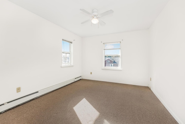 spare room with carpet, ceiling fan, and a baseboard heating unit