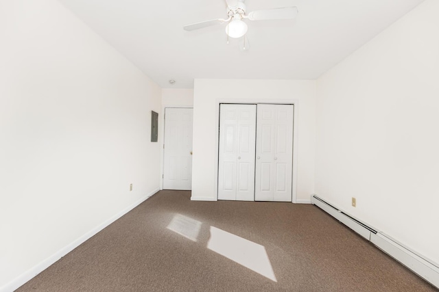 unfurnished bedroom featuring electric panel, a baseboard heating unit, ceiling fan, carpet floors, and a closet