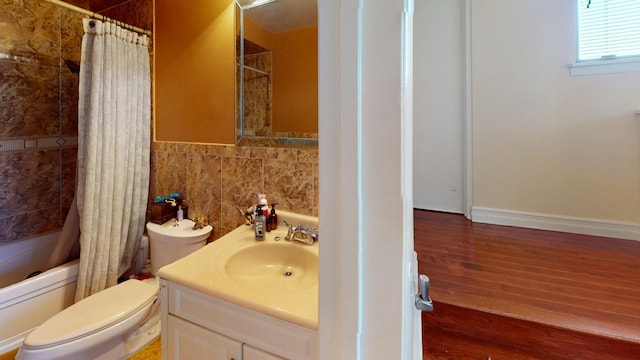 full bathroom featuring vanity, shower / bathtub combination with curtain, tile walls, hardwood / wood-style floors, and toilet