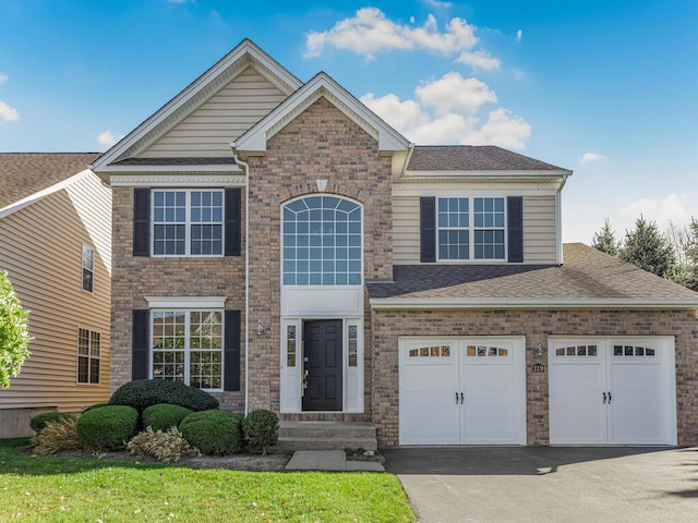 view of front of home with a front yard and a garage