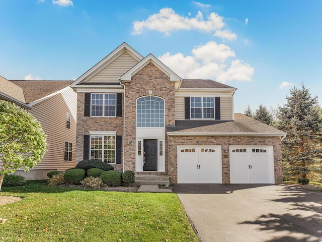 view of front of property featuring a garage and a front yard