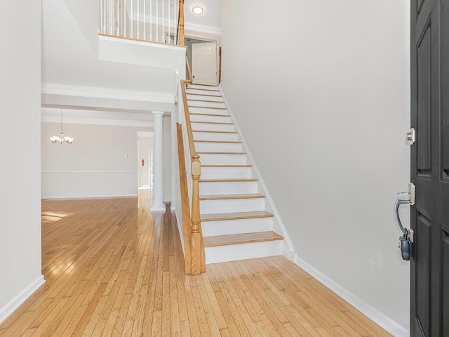 entryway featuring a chandelier and light hardwood / wood-style flooring