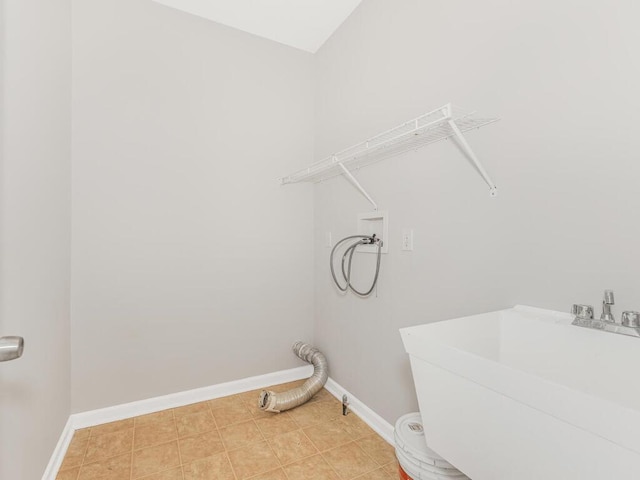 laundry room with tile patterned floors, sink, and hookup for a washing machine