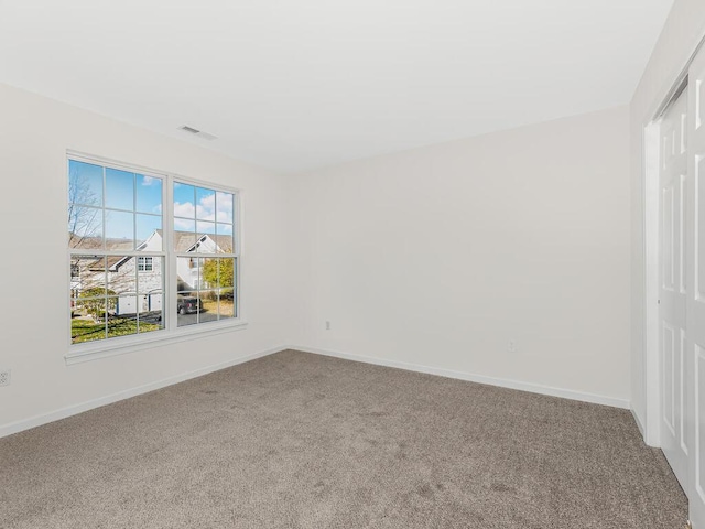 unfurnished room featuring carpet