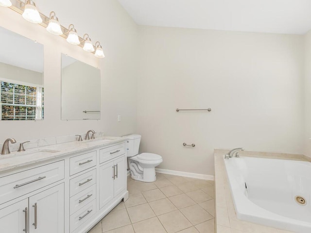 bathroom with tile patterned flooring, vanity, tiled bath, and toilet