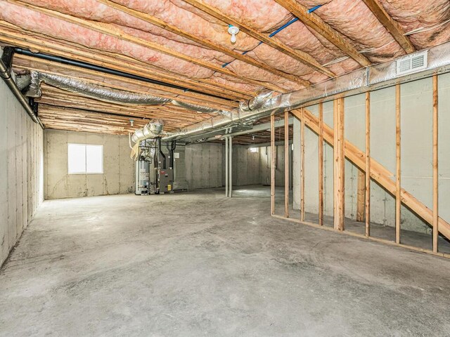 basement with heating unit and water heater