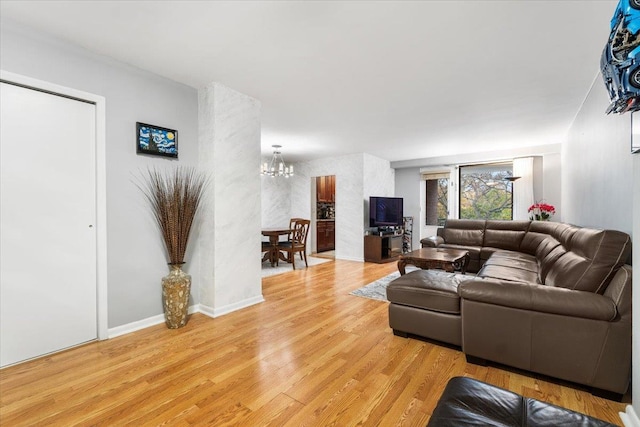 living room featuring light hardwood / wood-style flooring and a chandelier