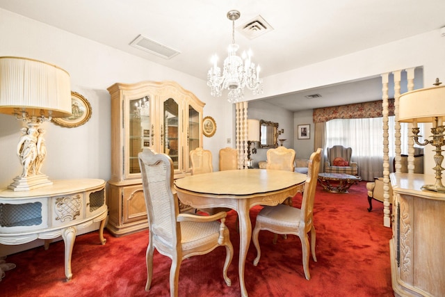 carpeted dining area with a chandelier