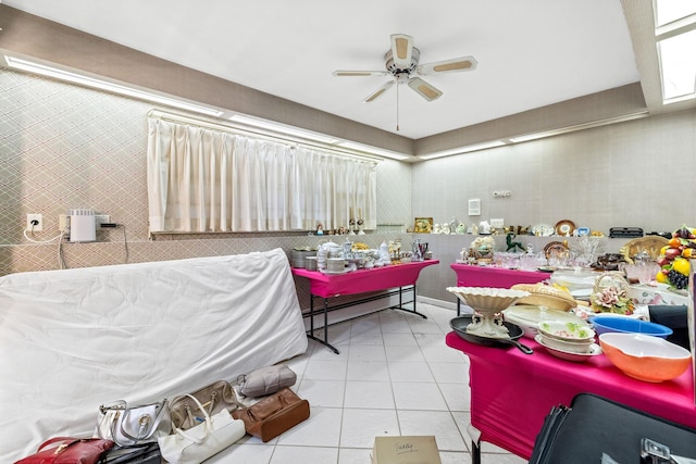 interior space featuring light tile patterned floors, a baseboard radiator, and ceiling fan