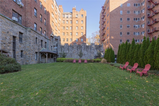 surrounding community with a gazebo and a yard