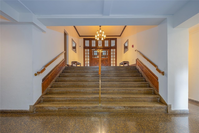 stairway with beam ceiling and an inviting chandelier