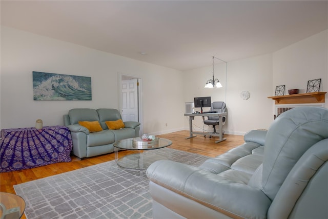 living room featuring hardwood / wood-style flooring and a notable chandelier