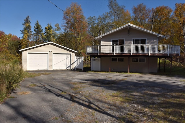 exterior space featuring an outdoor structure, a deck, and a garage