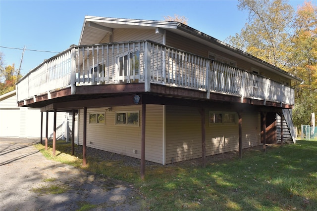 view of home's exterior with a lawn and a wooden deck