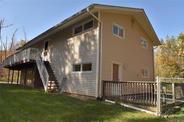 view of side of home with a yard and a deck