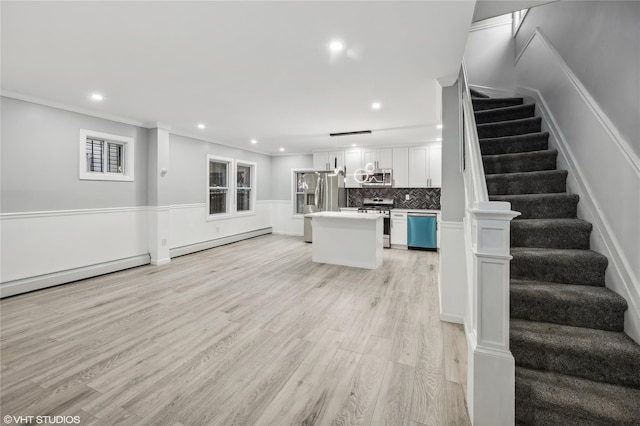 unfurnished living room featuring ornamental molding, light hardwood / wood-style floors, and a baseboard heating unit