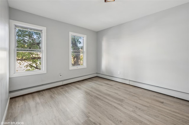 empty room with light hardwood / wood-style floors and a healthy amount of sunlight