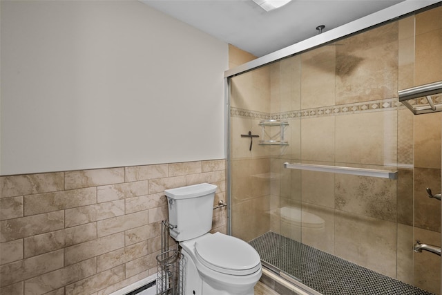 bathroom with toilet, baseboard heating, tile walls, and walk in shower