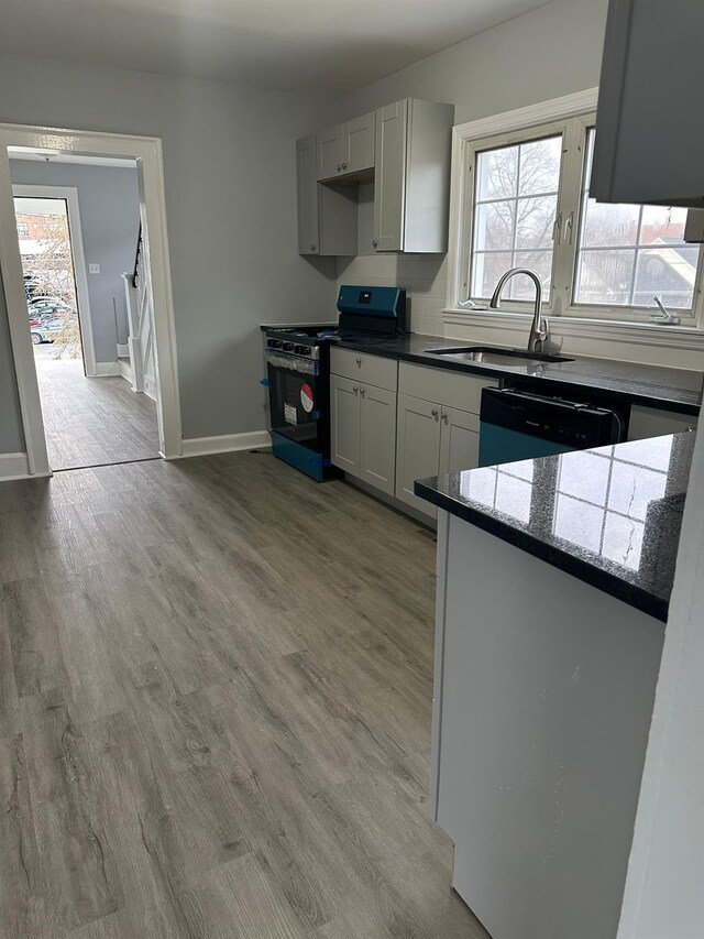 13 Farries Ave, Florida, NY 10921 - kitchen featuring black range, dishwashing machine, wood finished floors, stone counters, and white cabinets