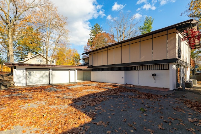 view of property exterior with a garage and an outdoor structure