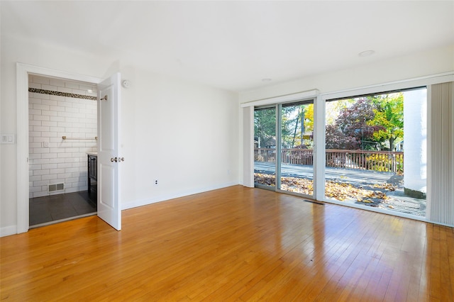 unfurnished room with wood-type flooring