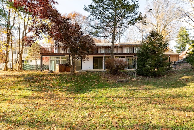 rear view of house featuring a yard