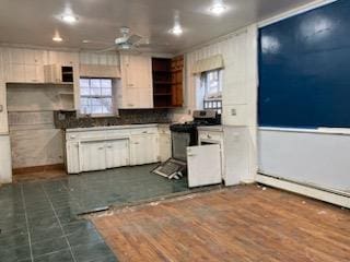 kitchen featuring white cabinets, ceiling fan, dark wood-type flooring, and electric stove