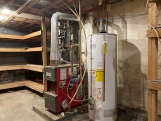 utility room featuring water heater