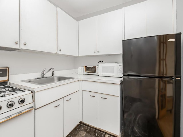 kitchen featuring white cabinetry, sink, and white appliances