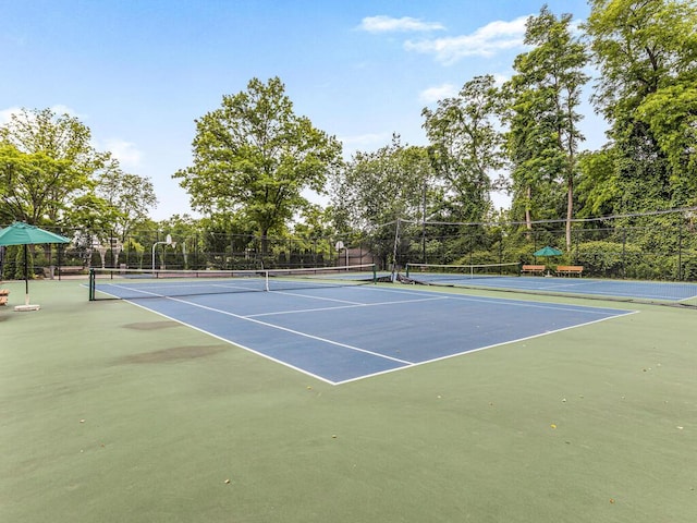 view of tennis court with basketball hoop