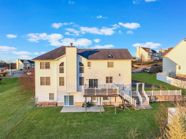 rear view of house featuring a patio, stairway, a deck, and a residential view
