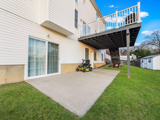 rear view of house featuring stairs, a patio, a lawn, and a deck