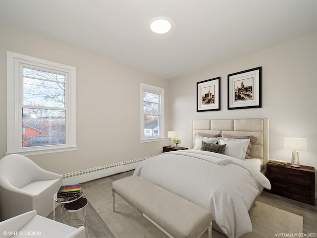 bedroom with baseboard heating and multiple windows