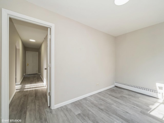 spare room featuring light hardwood / wood-style flooring and baseboard heating