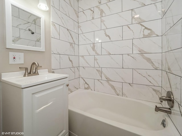 bathroom with vanity and tiled shower / bath