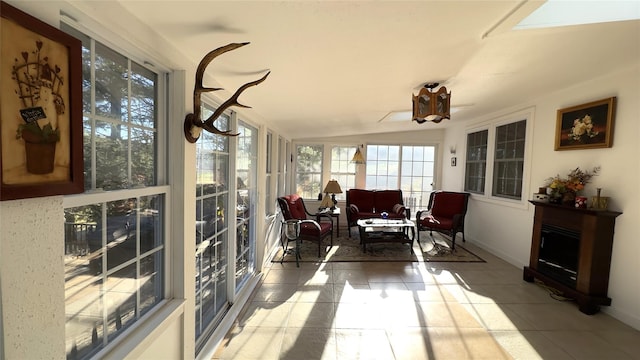 sunroom / solarium with a fireplace and lofted ceiling