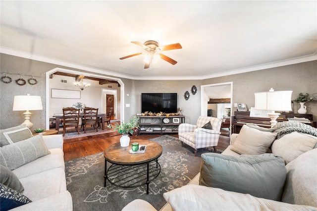 living room with hardwood / wood-style floors, ceiling fan with notable chandelier, and ornamental molding