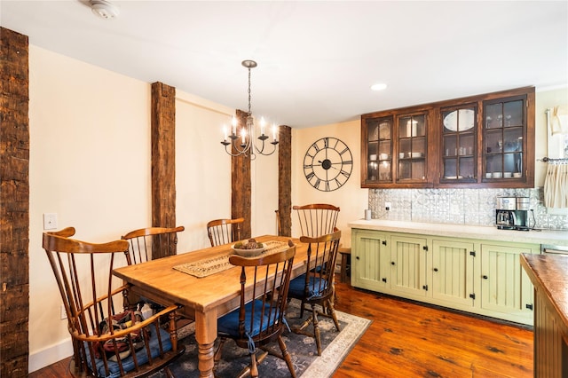 dining area with a chandelier and dark hardwood / wood-style flooring