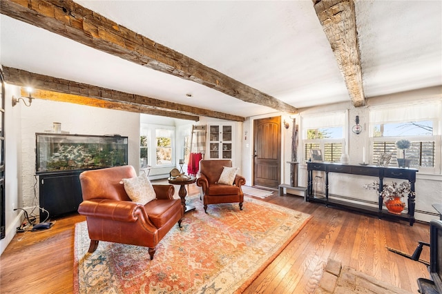 sitting room featuring hardwood / wood-style floors and beam ceiling