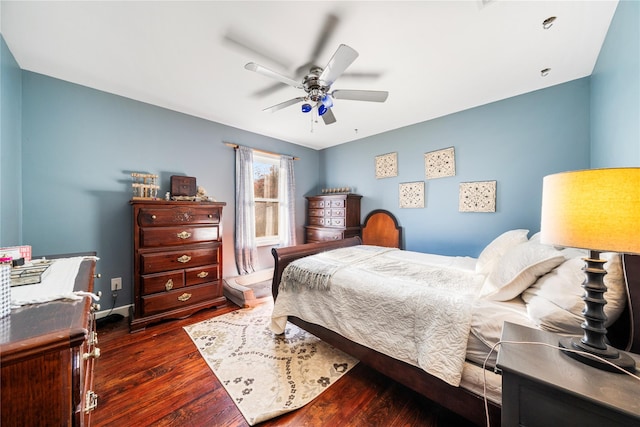 bedroom with ceiling fan and dark hardwood / wood-style flooring