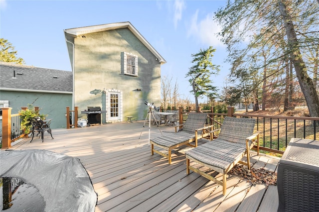 wooden deck featuring a grill